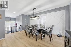 Dining room featuring light wood-type flooring and recessed lighting - 
