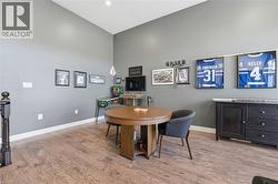 Dining space featuring light wood finished floors and a high ceiling - 