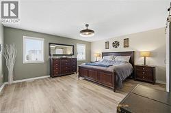 Bedroom featuring light wood-style floors and a textured ceiling - 