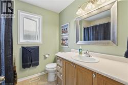 Bathroom with vanity, a shower with curtain, and light tile patterned floors - 