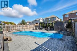 View of pool featuring a fenced backyard, a storage shed, a residential view, a patio area, and a pergola - 