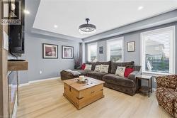 Living room featuring light wood finished floors and recessed lighting - 