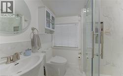 Bathroom featuring a marble finish shower, vanity, and marble finish flooring - 