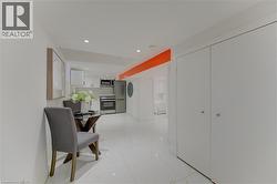 Hallway with recessed lighting and light marble finish floors - 