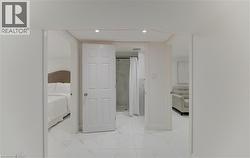 Hall featuring light marble finish flooring and recessed lighting - 