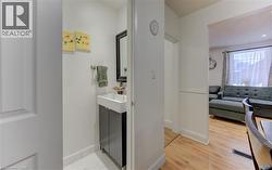 Ensuite bathroom featuring vanity and light wood-style flooring - 