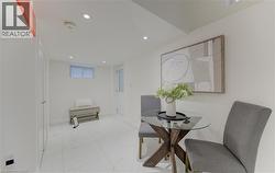 Dining area featuring recessed lighting and light marble finish flooring - 