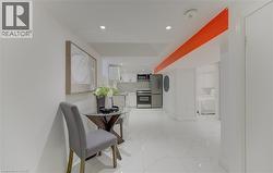 Corridor featuring recessed lighting and light marble finish floors - 