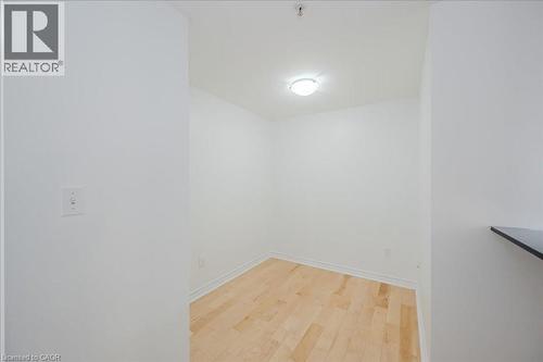 Unfurnished dining area with light wood-style flooring and baseboards - 41 Goodwin Drive Unit# 202, Guelph, ON - Indoor Photo Showing Other Room