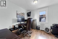 Home office featuring radiator and light wood-style flooring - 