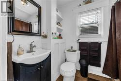 Bathroom featuring a shower with shower curtain, vanity, plenty of natural light, ornamental molding, and dark tile patterned floors - 
