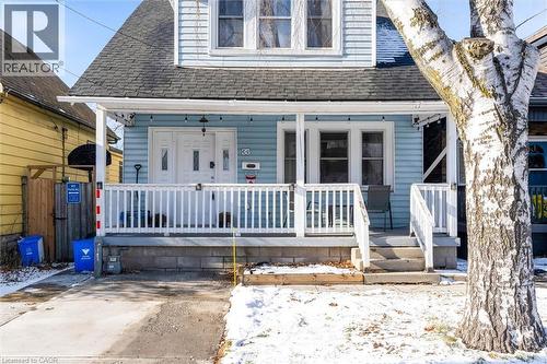 View of front facade featuring roof with shingles and covered porch - 35 Bayfield Avenue, Hamilton, ON - Outdoor With Deck Patio Veranda With Facade