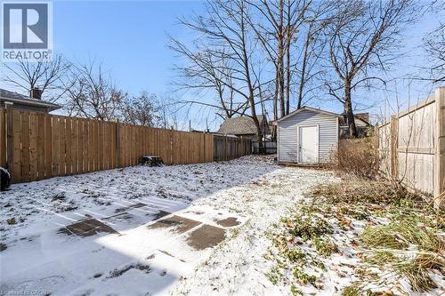 Snowy yard with a fenced backyard and a shed - 35 Bayfield Avenue, Hamilton, ON - Outdoor