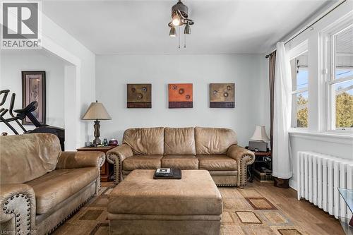 Living area featuring radiator, wood finished floors, and ceiling fan - 35 Bayfield Avenue, Hamilton, ON - Indoor Photo Showing Living Room