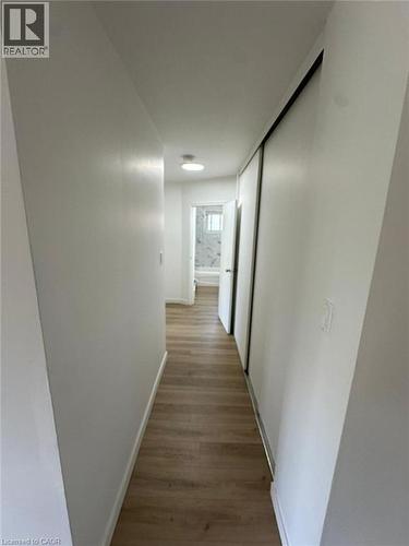 Hall with dark wood finished floors and baseboards - 145 Macgregor Crescent Unit# 1, Waterloo, ON - Indoor Photo Showing Other Room