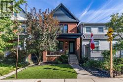 View of front of house featuring brick siding, a front yard, and a porch - 
