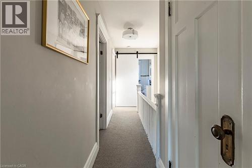 Hallway featuring carpet, a barn door, and an upstairs landing - 58 Chatham Street, Hamilton, ON - Indoor Photo Showing Other Room