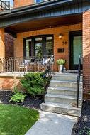 Property entrance featuring brick siding and covered porch - 