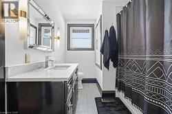 Bathroom with vanity and a shower with shower curtain - 