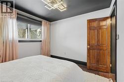 Bedroom with dark wood-type flooring and baseboards - 
