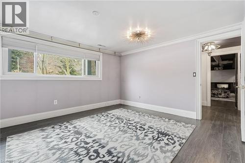 Spare room with dark wood-style flooring and ornamental molding - 13 Upper Canada Drive, Niagara-On-The-Lake, ON - Indoor Photo Showing Other Room