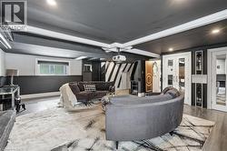 Living room featuring wood finished floors, recessed lighting, ornamental molding, and beverage cooler - 