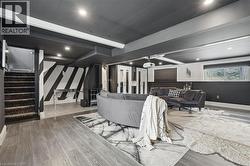 Living room featuring stairs and wood finished floors - 