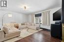 Living area featuring dark wood-style flooring, a chandelier, and a textured ceiling - 13 Upper Canada Drive, Niagara-On-The-Lake, ON  - Indoor Photo Showing Living Room 