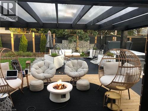 View of patio / terrace with an outdoor living space with a fire pit and a deck - 13 Upper Canada Drive, Niagara-On-The-Lake, ON - Outdoor With Exterior