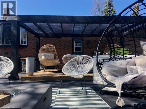 Wooden terrace with a pergola and an outdoor hangout area - 13 Upper Canada Drive, Niagara-On-The-Lake, ON - Outdoor
