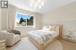 Bedroom featuring a chandelier and wood finished floors - 
