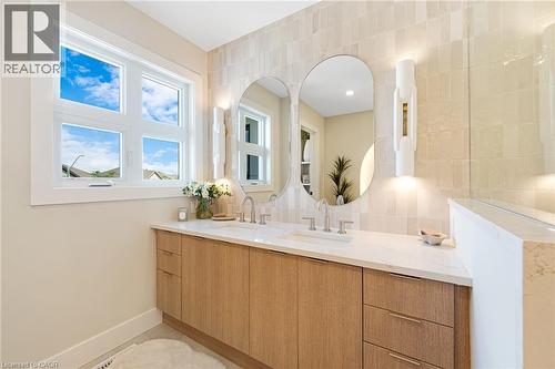 Bathroom with double vanity and tile walls - 452 Westhaven Street, Waterloo, ON - Indoor Photo Showing Bathroom