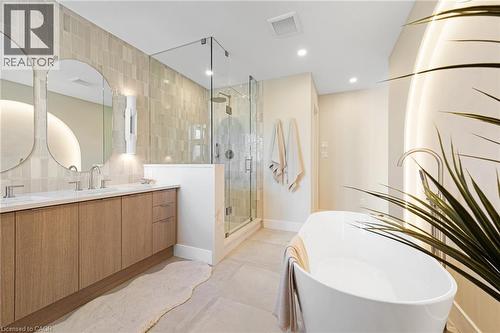 Bathroom with double vanity, tile walls, a stall shower, a freestanding bath, and recessed lighting - 452 Westhaven Street, Waterloo, ON - Indoor Photo Showing Bathroom