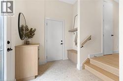 Entrance foyer with stairs and baseboards - 