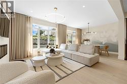 Living room with light wood finished floors and recessed lighting - 