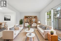 Virtually Staged living room with patio door access to rear yard. - 