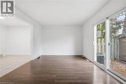 Bright, living room with laminate flooring features patio door access to rear yard. - 