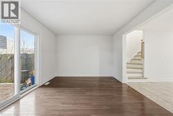 Spacious living room features laminate flooring and access to sliding patio door, opening to private rear yard. - 