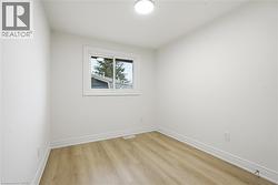 Bedroom 2 with laminate flooring, LED lighting, window and closet. - 