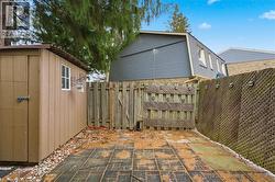 Private rear yard is fully fenced with shed for extra storage. - 