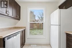 Clean-up is a snap with built-in dishwasher & plenty of counter space! The large window adds natural light & overlooks front garden. - 