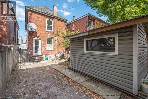 Back of property featuring a chimney, an outbuilding, and brick siding - 934 Barton Street E Unit# 2, Hamilton, ON - Outdoor