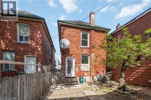 Rear view of house with brick siding, a chimney, and a patio area - 934 Barton Street E Unit# 2, Hamilton, ON - Outdoor