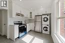 Kitchen with healthy amount of natural light, appliances with stainless steel finishes, white cabinets, light countertops, and recessed lighting - 934 Barton Street E Unit# 2, Hamilton, ON  - Indoor Photo Showing Laundry Room 