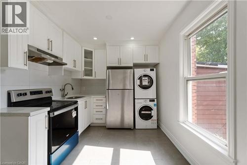 Kitchen featuring appliances with stainless steel finishes, white cabinetry, light countertops, under cabinet range hood, and recessed lighting - 934 Barton Street E Unit# 2, Hamilton, ON - Indoor Photo Showing Kitchen With Double Sink