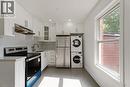 Kitchen featuring appliances with stainless steel finishes, white cabinetry, light countertops, under cabinet range hood, and recessed lighting - 934 Barton Street E Unit# 2, Hamilton, ON  - Indoor Photo Showing Kitchen With Double Sink 