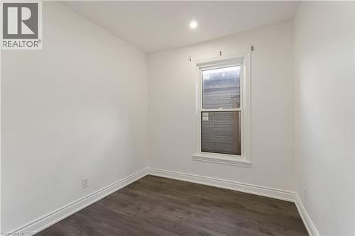 Unfurnished room featuring dark wood-style flooring and recessed lighting - 934 Barton Street E Unit# 2, Hamilton, ON - Indoor Photo Showing Other Room