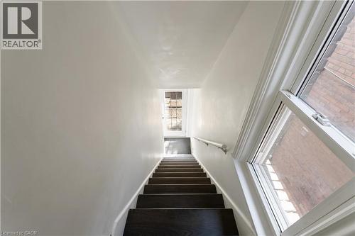 Stairs featuring baseboards and wood finished floors - 934 Barton Street E Unit# 2, Hamilton, ON - Indoor Photo Showing Other Room