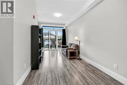 Sitting room featuring light Laminate flooring and baseboards - 