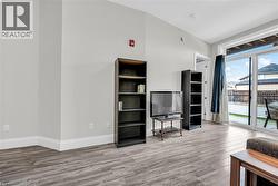 Living room with light laminate flooring and baseboards - 